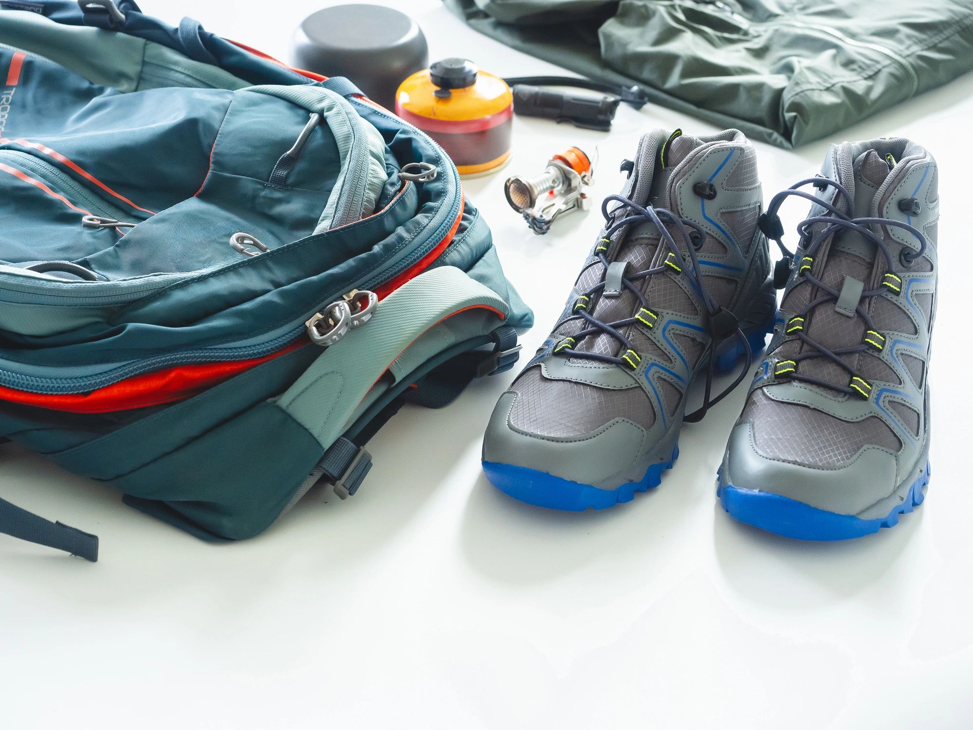 Camping and hiking equipment including backpack, boots, and cooking gear