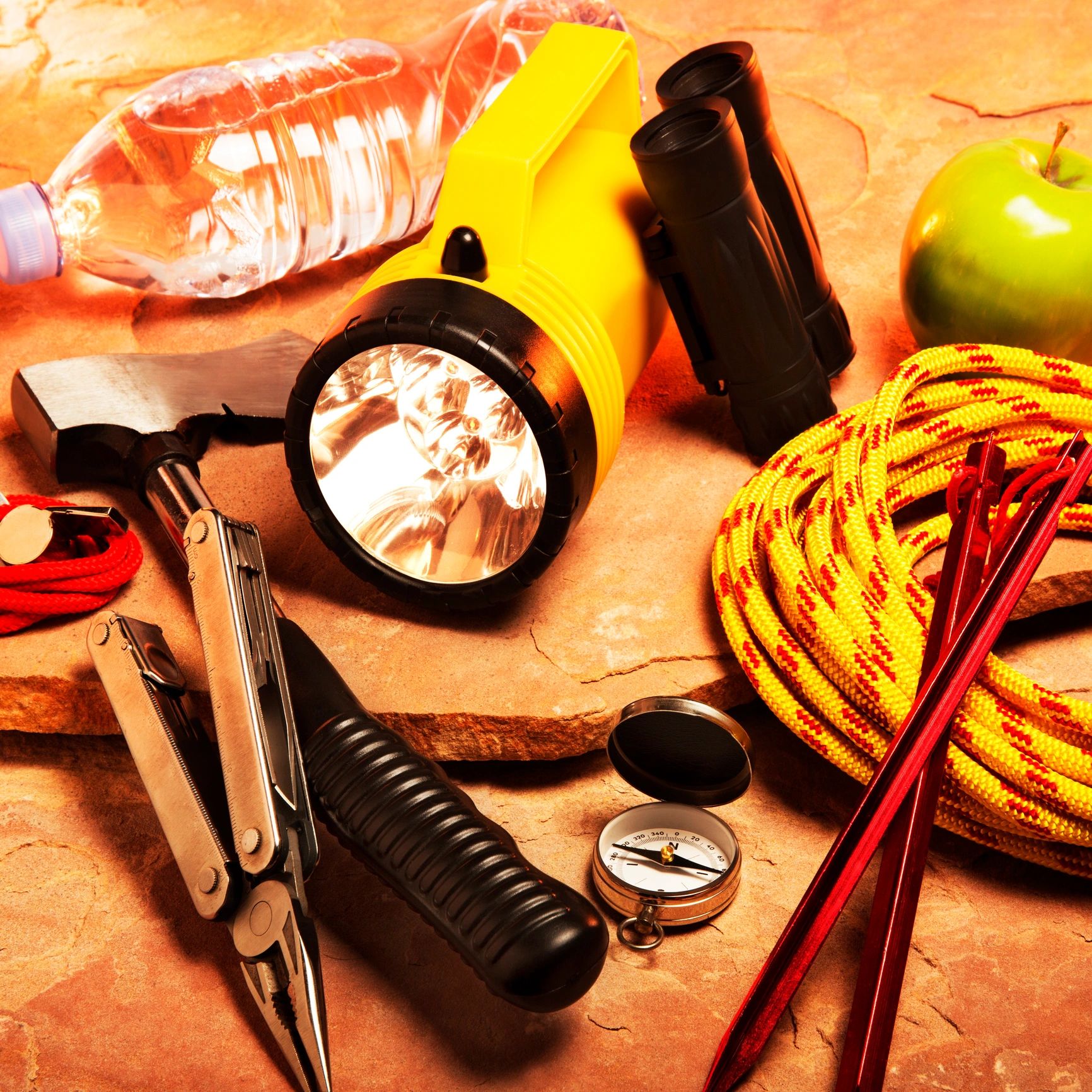 Camping supplies arranged on red rock